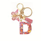 Porte-clés femme lettre initiale colorée – Breloque papillon et pompon rose tendance
